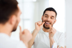 Man putting invisalign aligners in