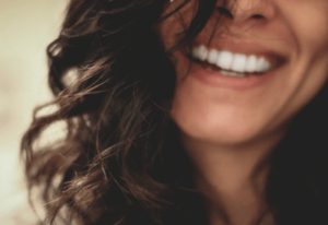 Woman with Invisalign treatment smiling