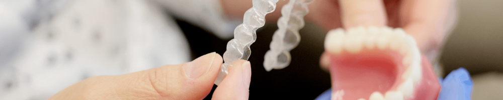 a dentist outlining the Invisalign treatment process in Stafford