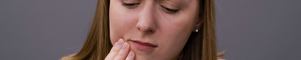 woman with teeth grinding in stourbridge holding face