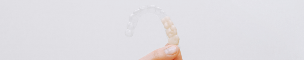 Woman holding Invisalign braces in Stourbridge