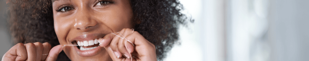 woman in stourbridge flossing teeth