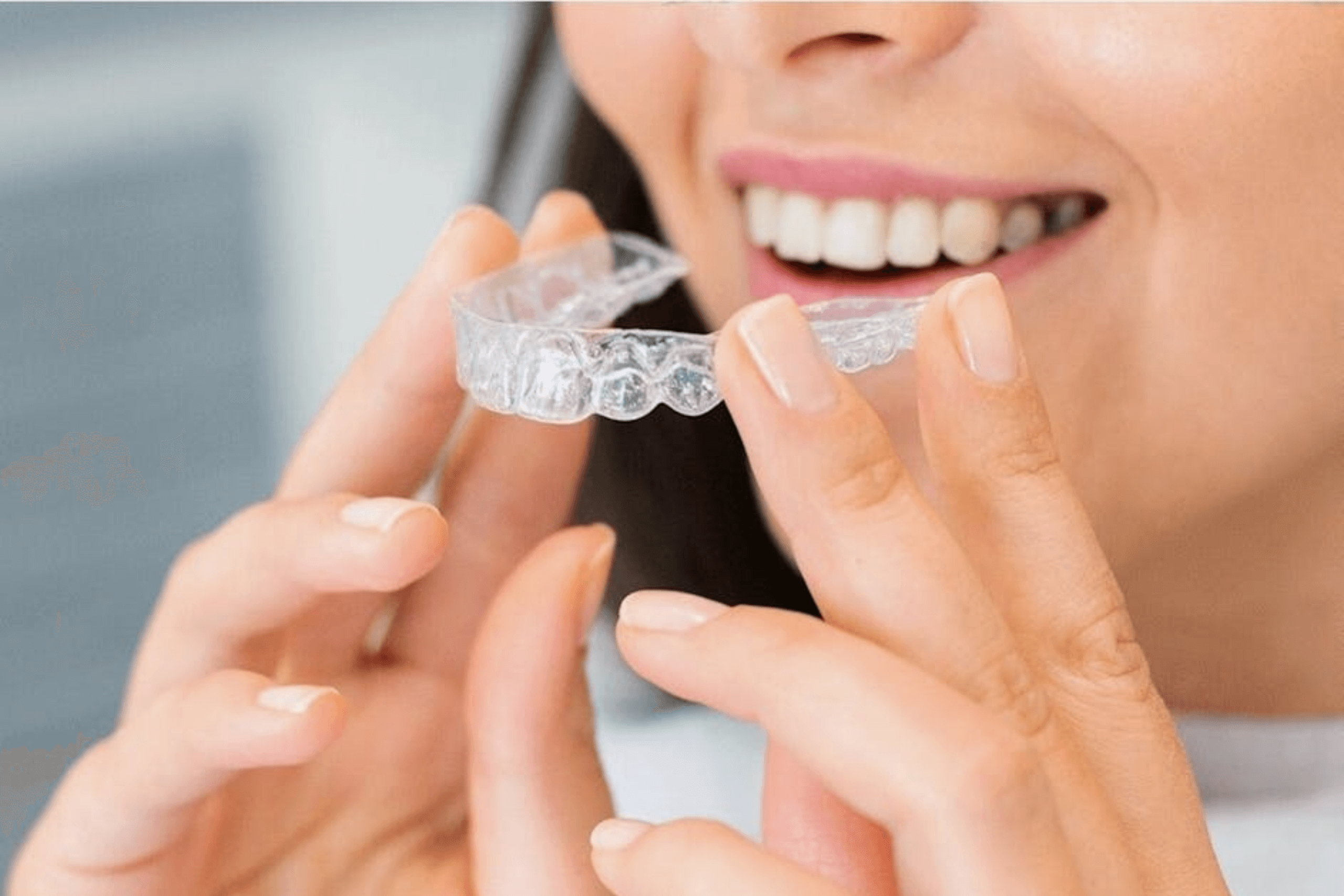 woman holding invisalign aligners at stella dental in stourbridge